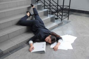 Woman injured after falling down stairs in office building, representing slip and fall accident and premises liability claim.