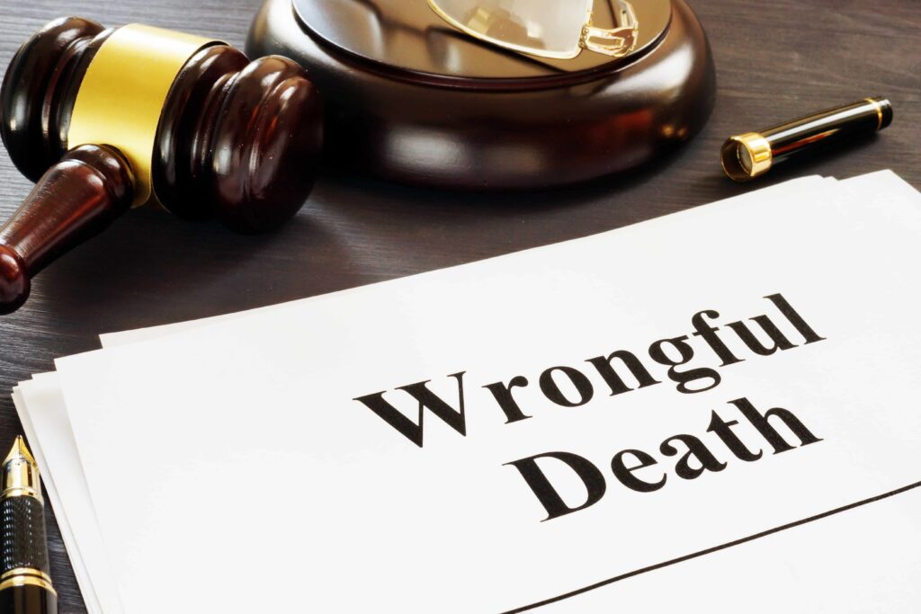 Wrongful death legal document with judge&rsquo;s gavel and pen on desk, representing wrongful death lawsuit and fatal accident claim.