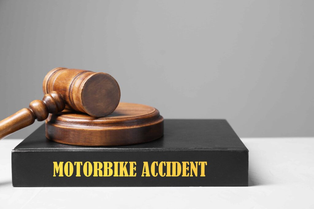 Judge&rsquo;s gavel on law book labeled &ldquo;motorbike accident,&rdquo; symbolizing motorcycle accident legal case or personal injury claim